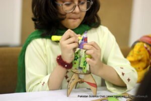 young girl scientist making a chemical-powered rocket in science activity